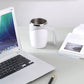 Electric white electric stirring cup with stainless rim and curved handle.
