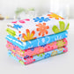 Stack of 4 microfiber cleaning towels with bright floral prints in blue, pink, green, and white