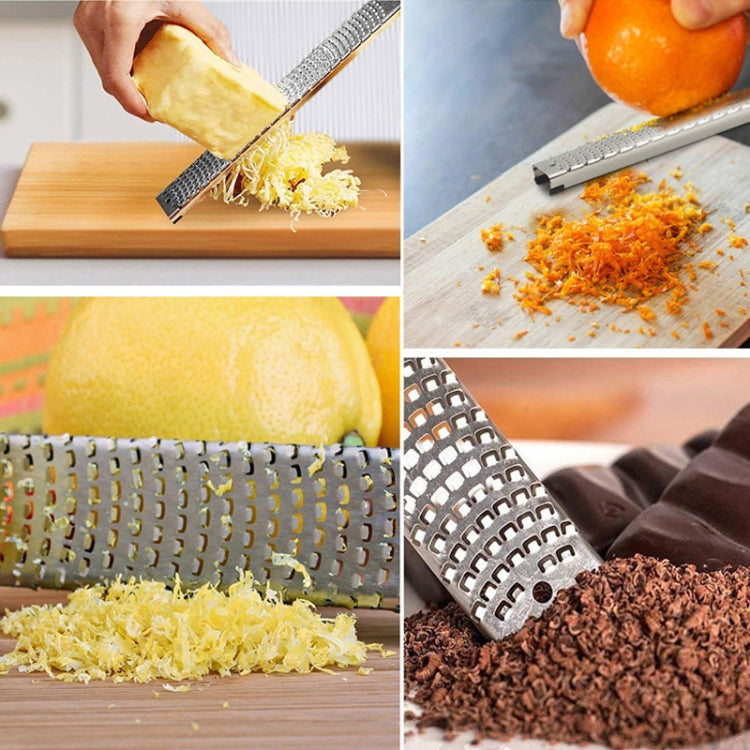 Stainless steel grater with fine teeth producing shredded cheese and chocolate.