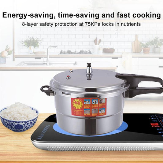 Stainless steel pressure cooker on a black induction-style cooktop base