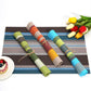 Rolled striped PVC placemats set in brown, orange, green, and blue color options