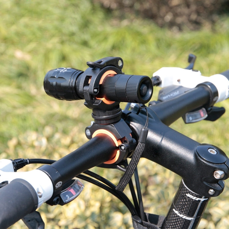 Black and orange bike flashlight clip bracket mounted on handlebar