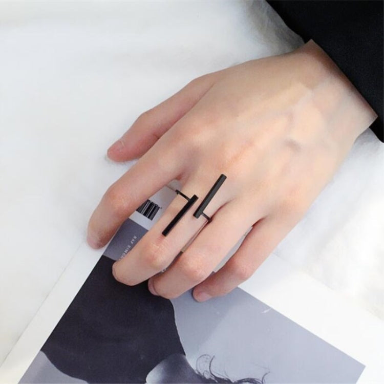 Black geometric open finger ring on hand, two bar accents over open band
