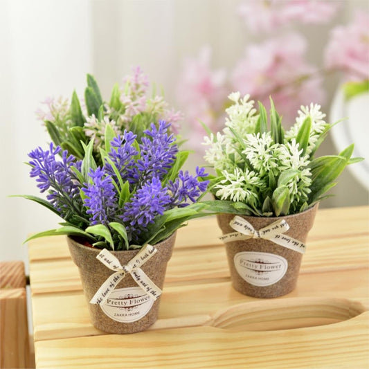 Pair of artificial potted flowers: purple and white blossoms with green leaves in gray pots
