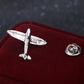 Silver retro airplane brooch pin with round backing on velvet