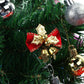 Close-up Christmas bow pendant with red ribbon and gold bell dangles