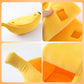 Banana-shaped pet nest in yellow plush with inner seam detail and label patch