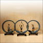 Set of three blue and gold resin yoga pose statues with seated figures on black bases