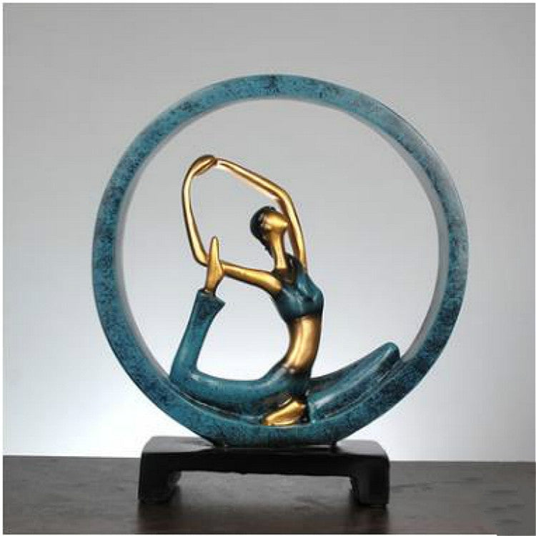 Blue and gold resin yoga pose statue with an open-arm figure inside a round ring