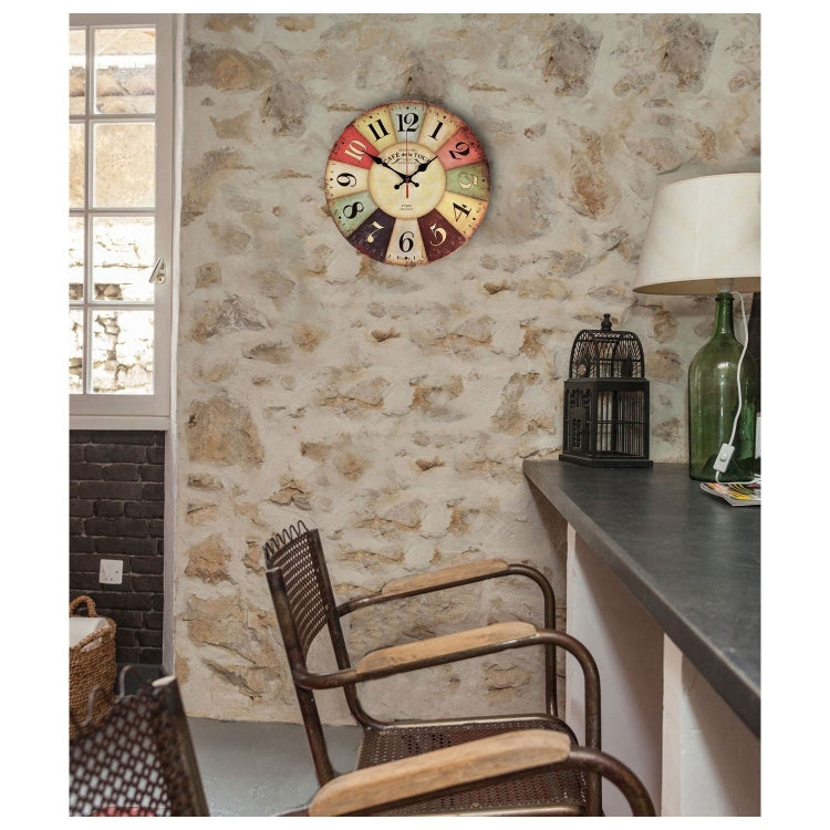 Vintage wall clock mounted on stone wall, round distressed dial with black hands.
