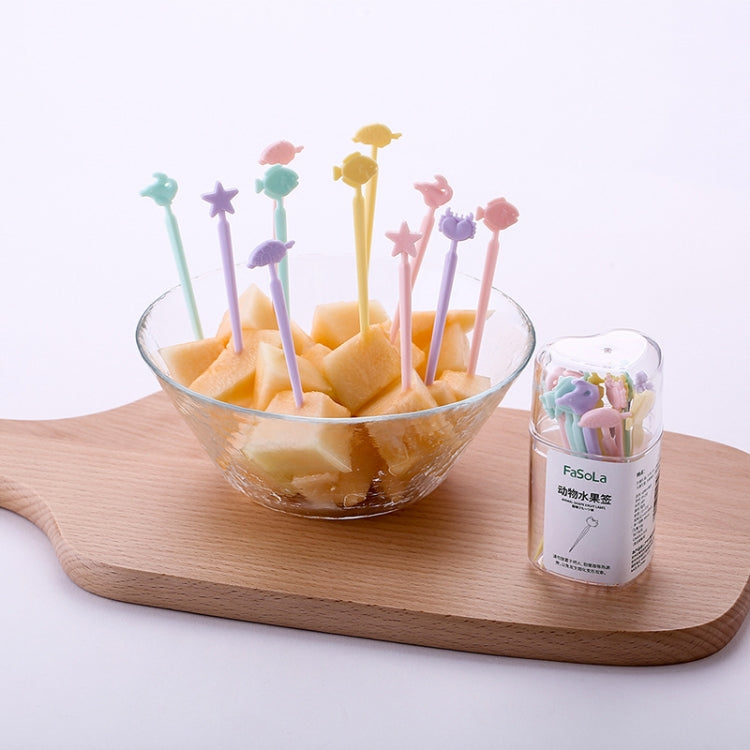 Set of colorful cartoon cake forks with star and animal tops in fruit bowl