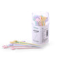 Transparent container of pastel cartoon cake forks with animal and star toppers