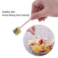 Hand holding pastel cartoon cake fork above fruit salad bowl