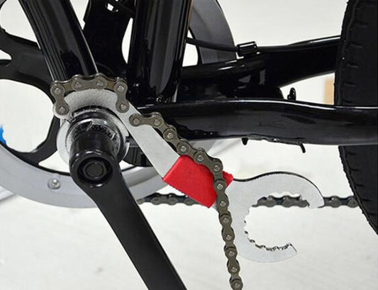 Bicycle chain wrench and chain tool positioned on a mountain bike drivetrain