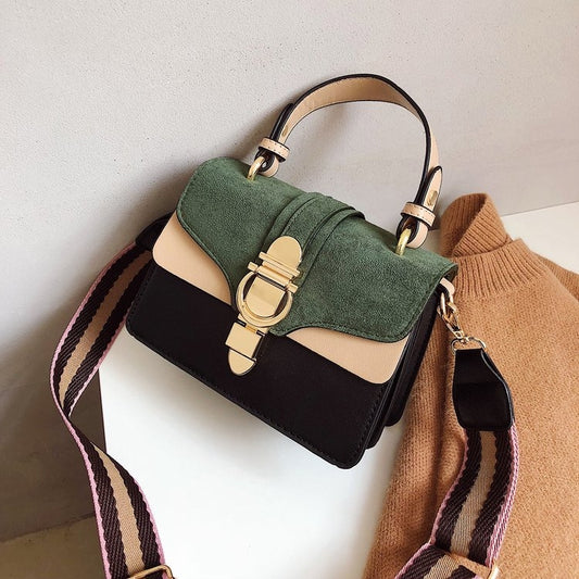 Green suede-look flap handbag with black base, gold clasp, and striped crossbody strap