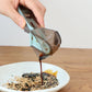Adjustable plastic measuring spoon pouring into food, light-blue handle and smoky cup