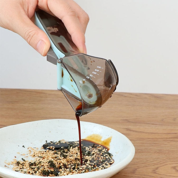 Adjustable plastic measuring spoon pouring into food, light-blue handle and smoky cup
