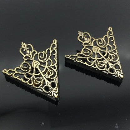 Pair of gold hollow pattern triangular collar buckles with ornate filigree cutouts