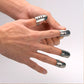 Adjustable stainless steel finger guards shown being fitted by hands