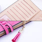 Long zip wallet interior with striped card slots and pink tassel on zipper