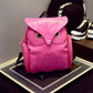 Pink owl-pattern mini backpack with owl eyes and adjustable shoulder straps