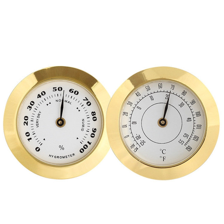 Gold analog hygrometer showing humidity % scale and temperature °C/°F dial