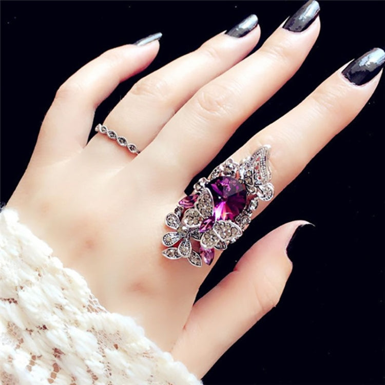 Purple butterfly gemstone statement ring with thin crystal band on hand