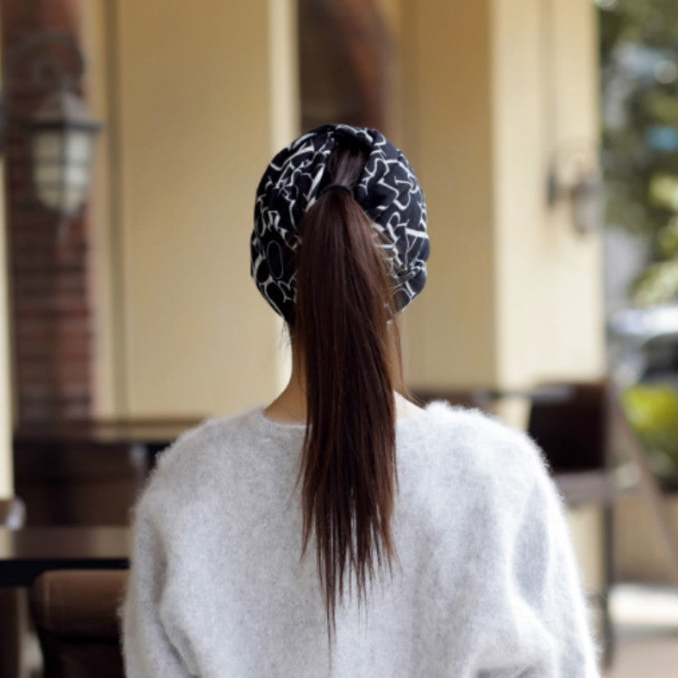 Women’s letter-print turban cap, black with white letters, back view