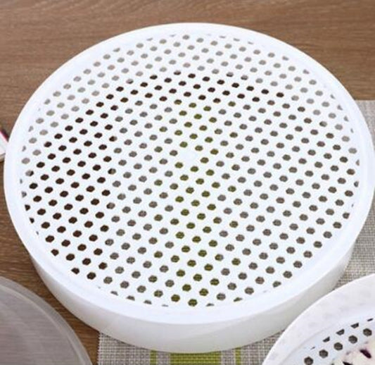 White perforated steaming plate with many holes for microwave steamer