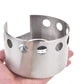 Stainless steel stove windscreen bowl with oval ventilation holes, held in hand
