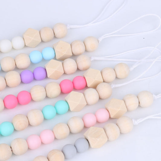 Colorful wooden pacifier clip straps with round beads, geometric spacer beads, and face charm