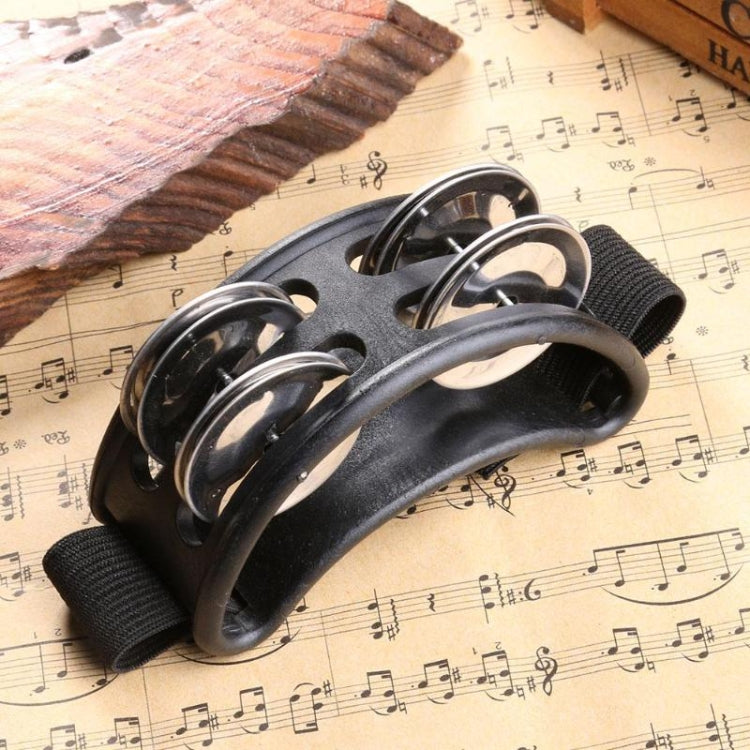 Black aluminum cajon foot bell with three chrome tone discs and attached strap