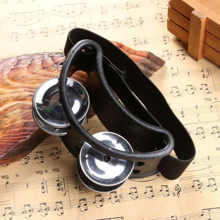 Black aluminum percussion cajon foot bell with three chrome tone discs and strap