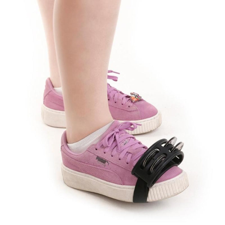 Pink aluminum percussion cajon foot bell worn on sneaker with three chrome discs