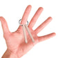 Beech wood mini drumstick keychain held in a hand with silver round ring