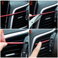 Hand installing red U-shaped car AC vent trim strip on dashboard vent grille