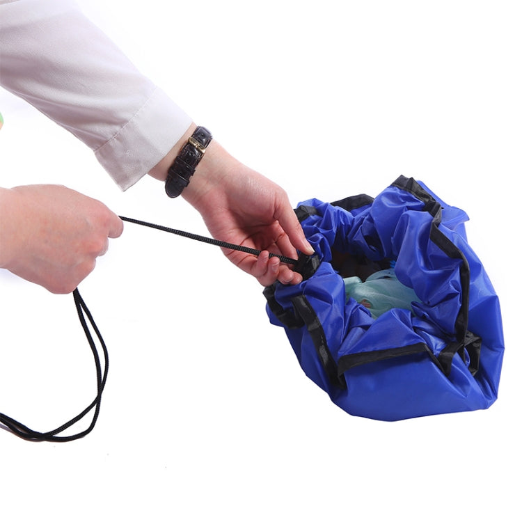 Blue round toy storage bag being closed with black drawstring cord