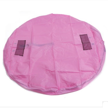 Pink round kids toy storage bag with drawstring closure and black carry straps
