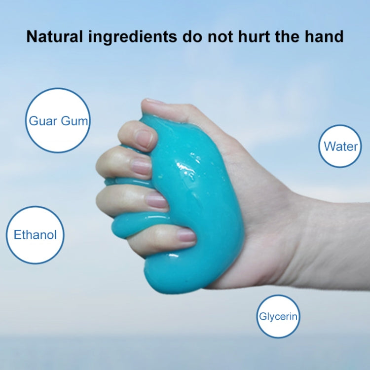 Sky blue cleaning gel sticker held in hand on car interior surface