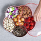 Pink flower-shaped snack storage box, divided tray compartments with snacks inside