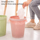 Removable plastic trash bin with lid, pink woven pattern, trash bag lifted for disposal