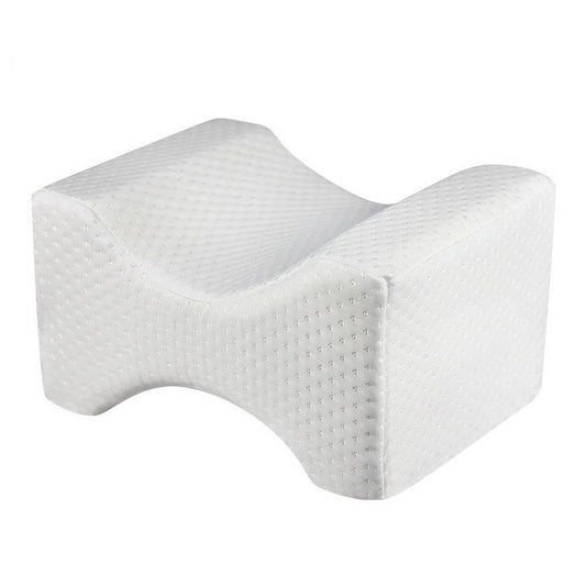 White orthopedic knee wedge pillow with curved contour and textured foam surface
