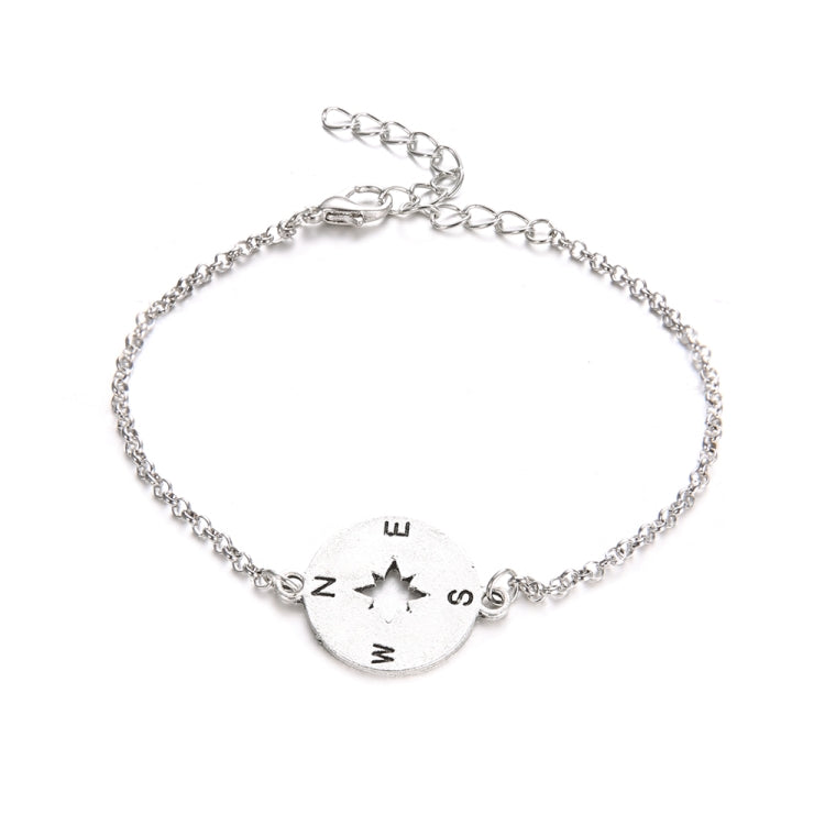 Silver-toned beaded bracelet with round compass charm marked N, E, S, W and arrow