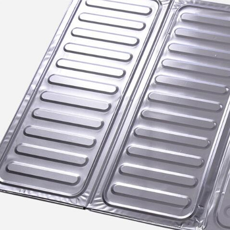 Close-up of louvered stainless steel cooktop oil shield panels
