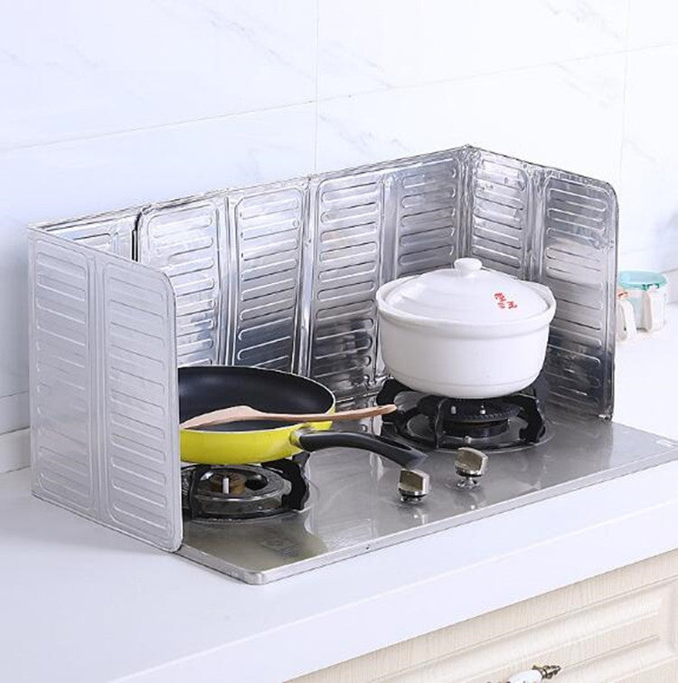 Cooktop oil shield panels around a small pot on the stove-top