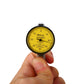 Handheld dial indicator with yellow measurement scale