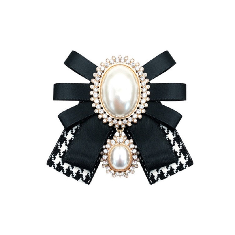 Black and white patterned ribbon bow brooch with oval pearl centers and rhinestone edges