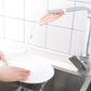 Pink toddler faucet extender with angled spout directing water into sink