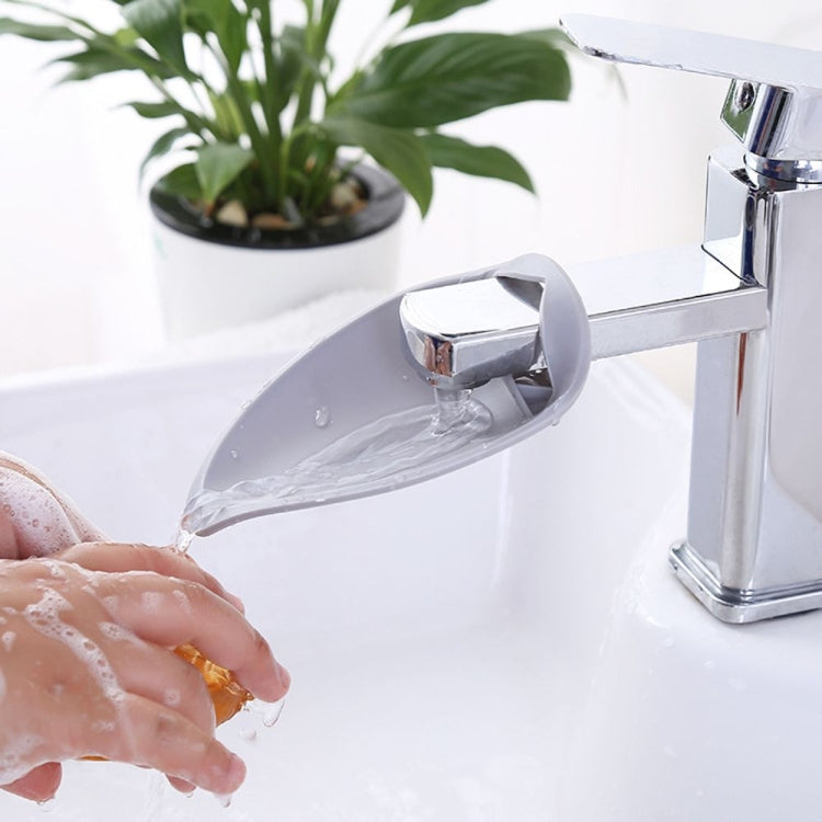 Gray toddler faucet handle extender with water stream through angled spout