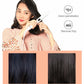 Hair straightener in use on black hair, showing LED display on the handle